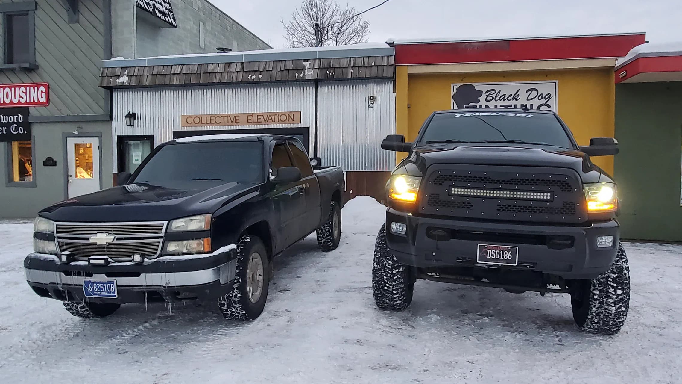 Lifted Black Dog truck lineup outside the Bozeman shop