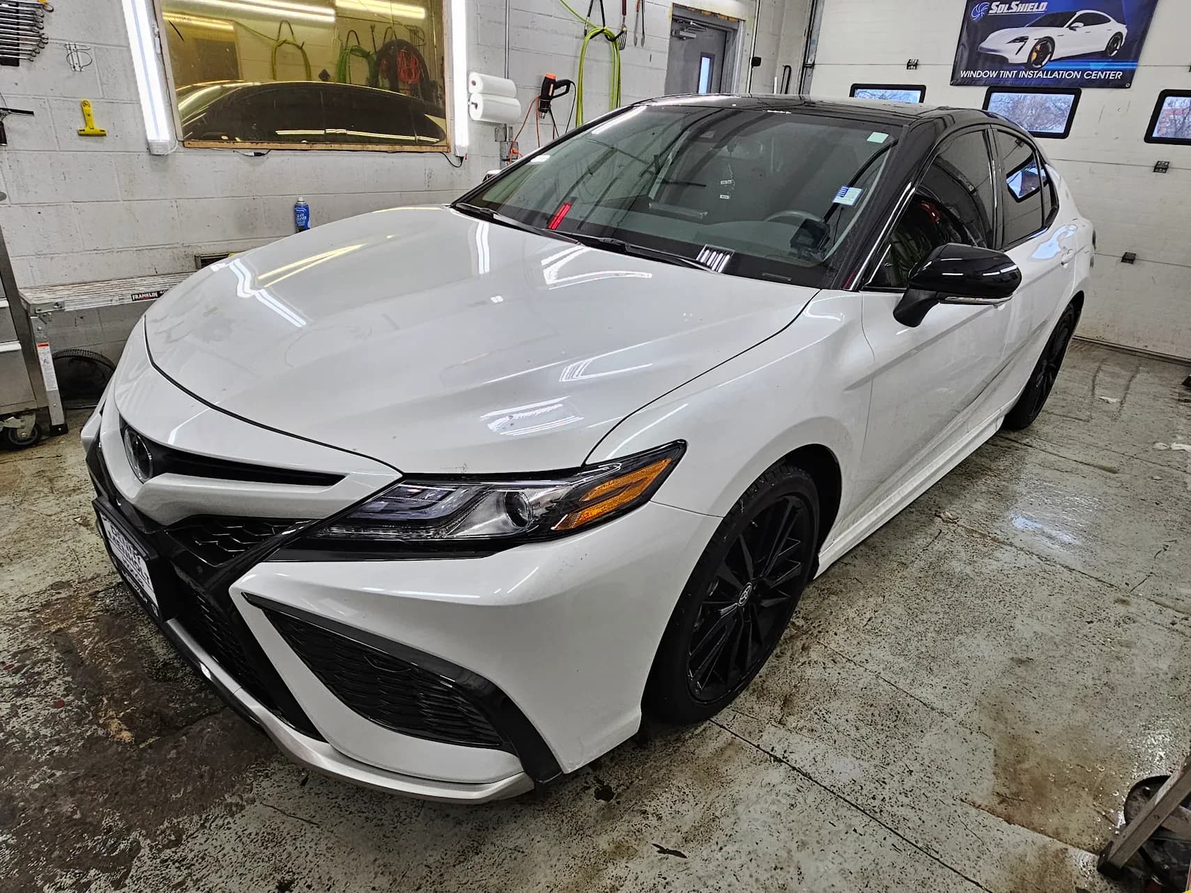 White Toyota sedan after ceramic window tint