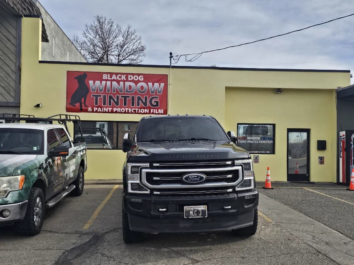 Black Ford truck under the Black Dog shop sign