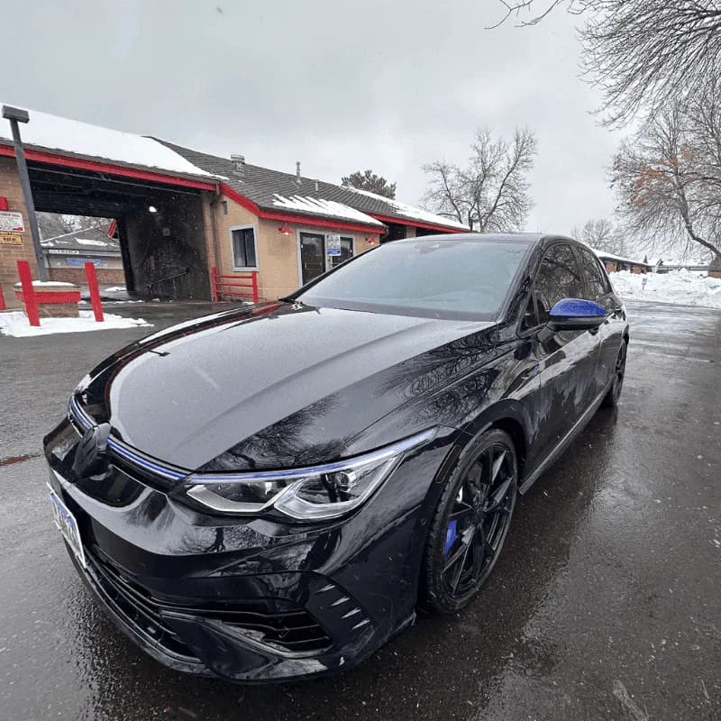 Black coupe after tint work in the snow